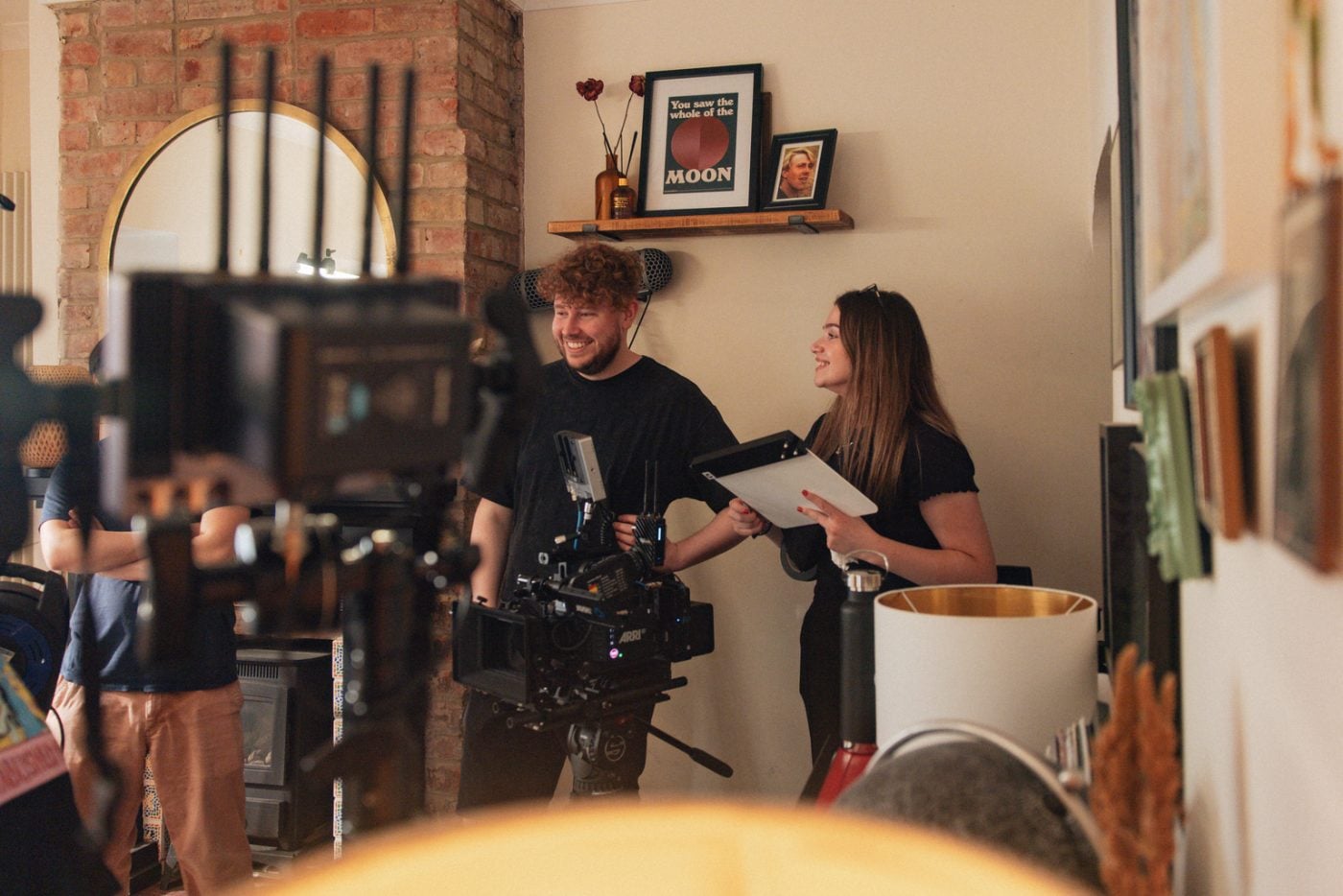 male and female on set inside the room.